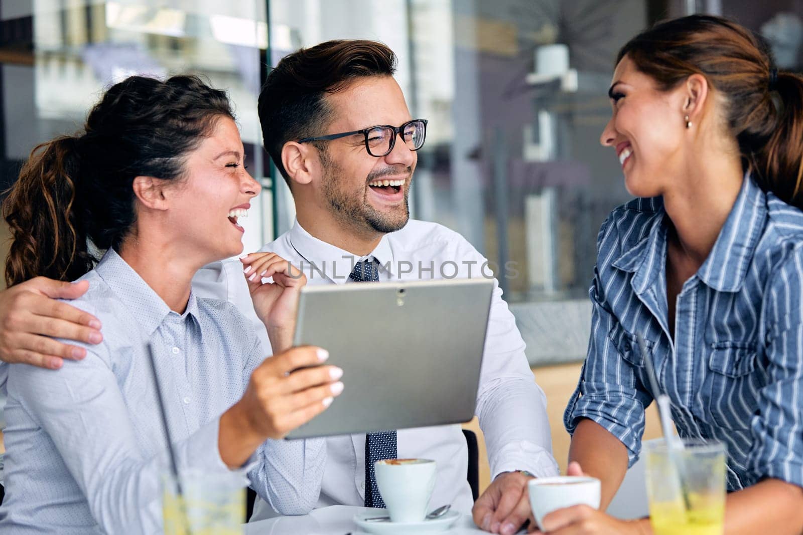 Friends having fun in a restaurant or cafeteria coffee shop. Young businesspeople during a break