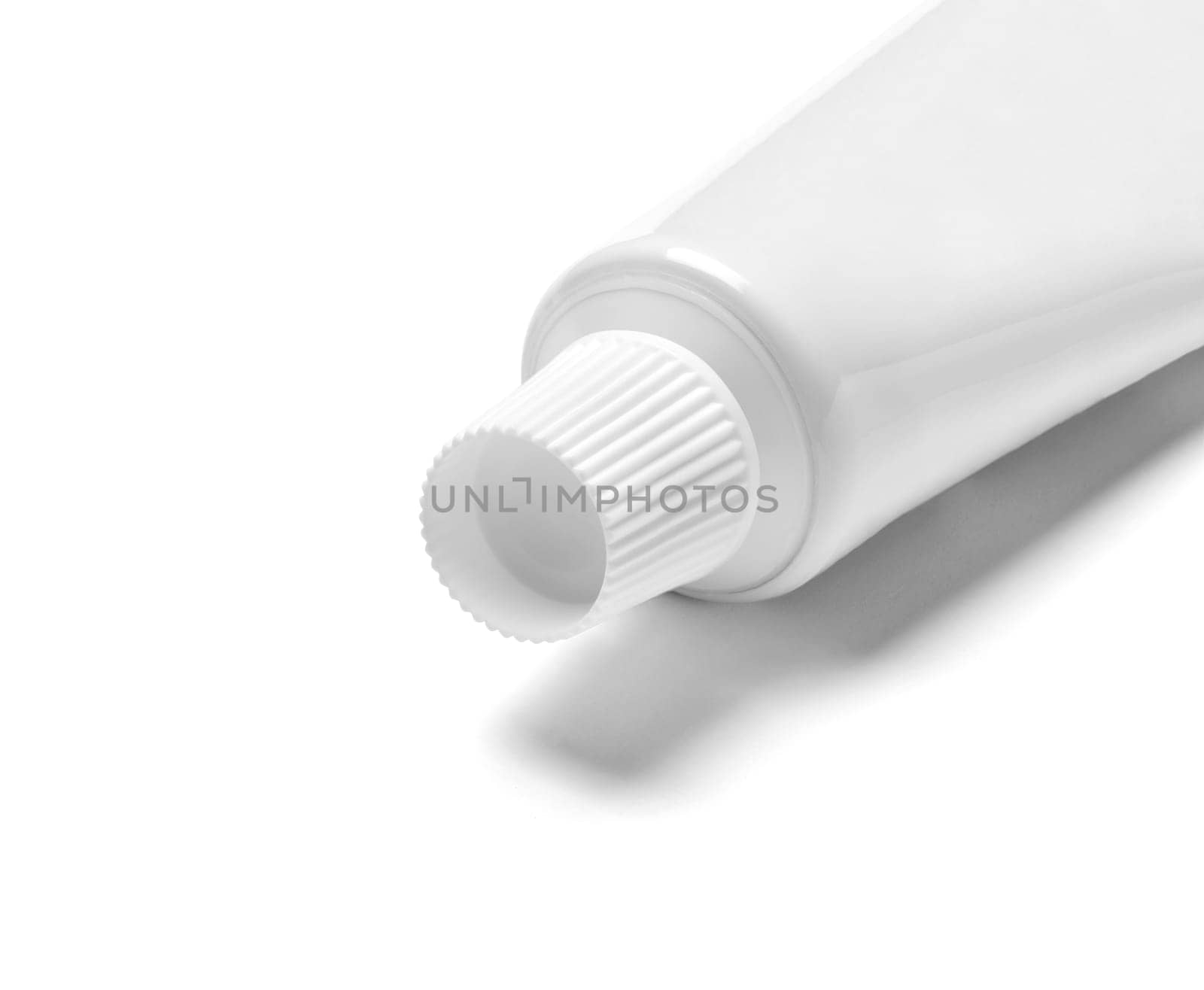 close up of a toothpaste or beauty cream tube on white background