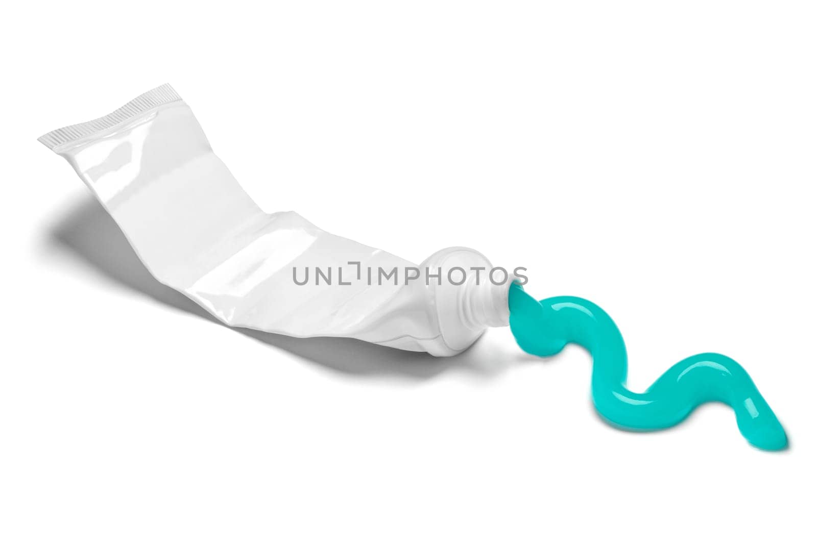 close up of a used empty toothpaste tube on white background