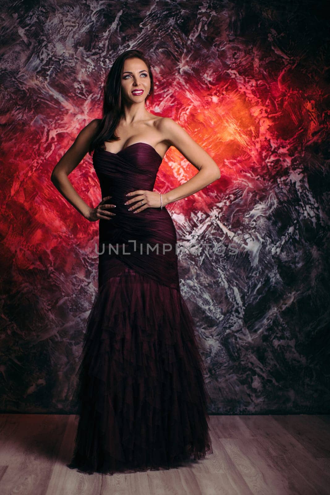 gorgeous sexy woman in evening dress posing over dark background