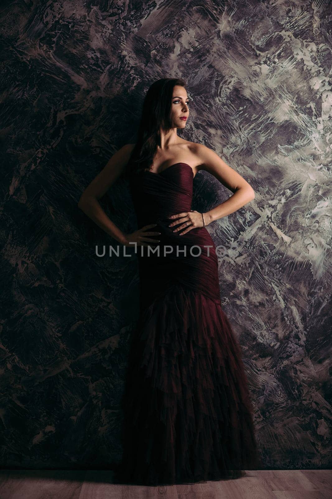 gorgeous sexy woman in evening dress posing over dark background