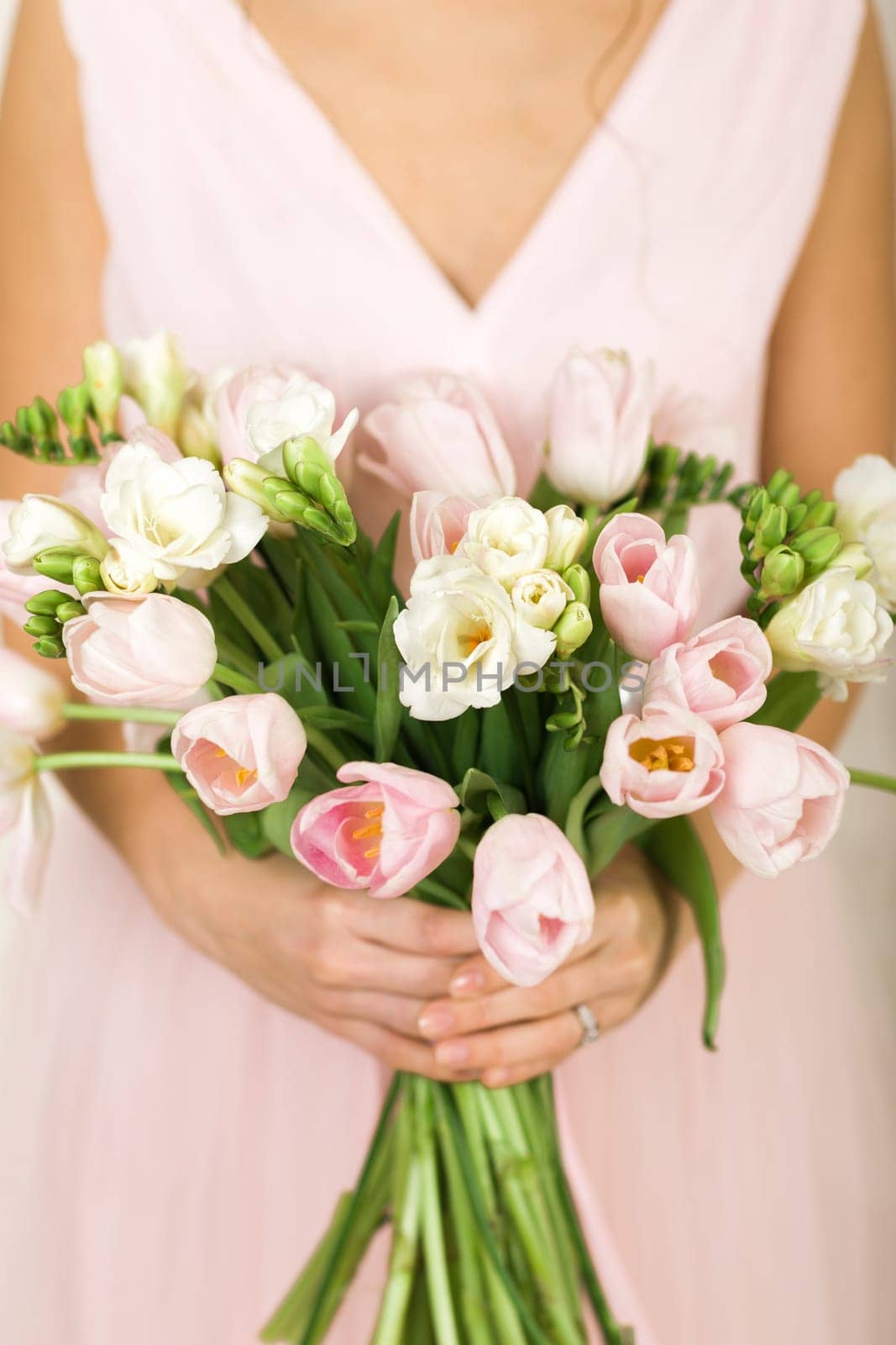 Wedding bouquet of pink tulips in bride's hands