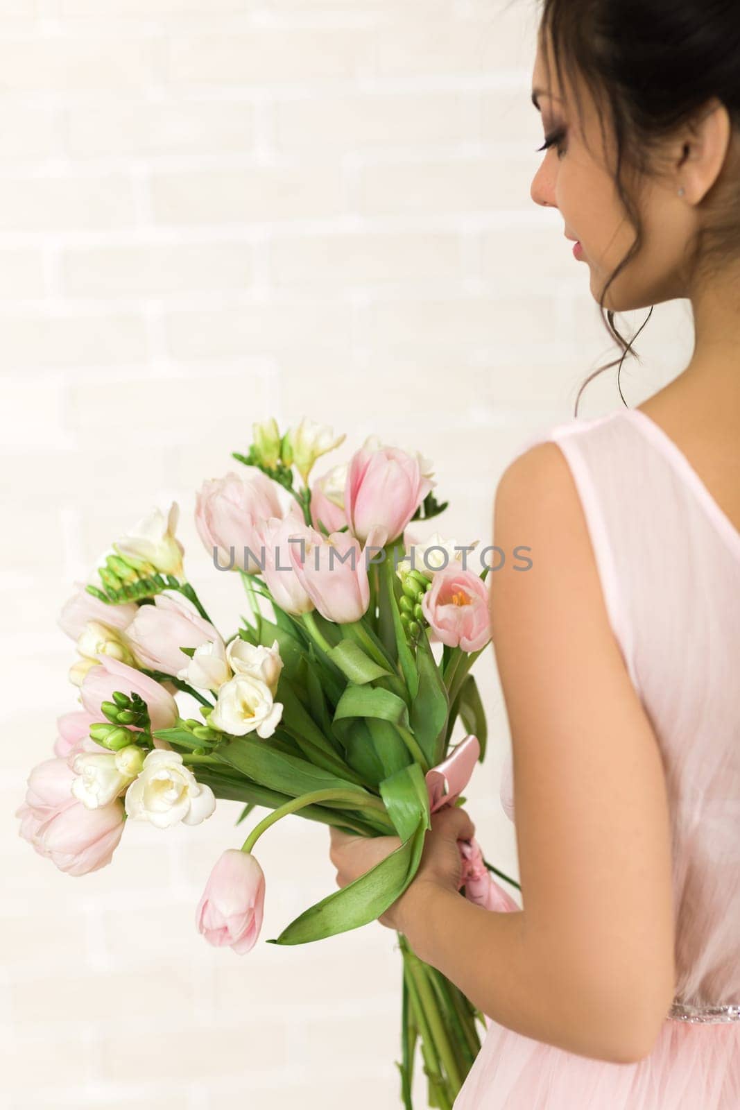 Wedding bouquet of pink tulips in bride's hands