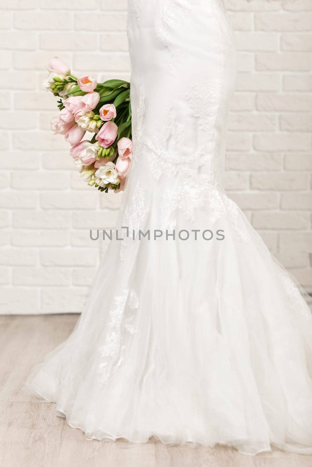 Wedding bouquet of pink tulips in bride's hands