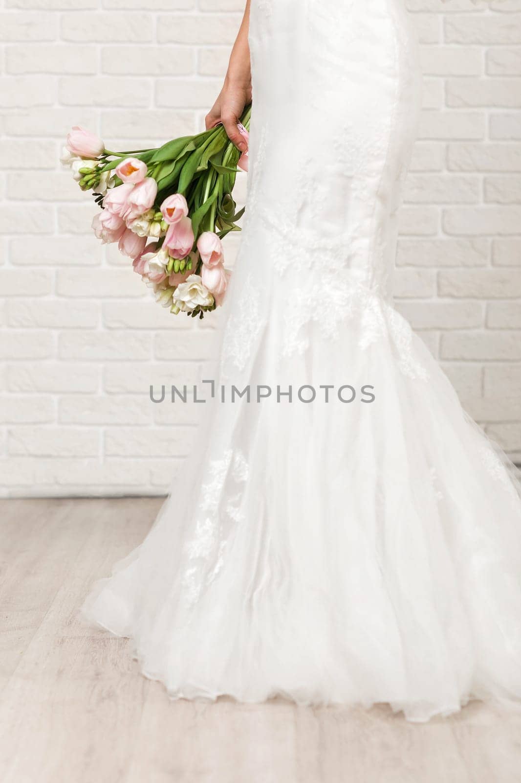 Wedding bouquet of pink tulips in bride's hands