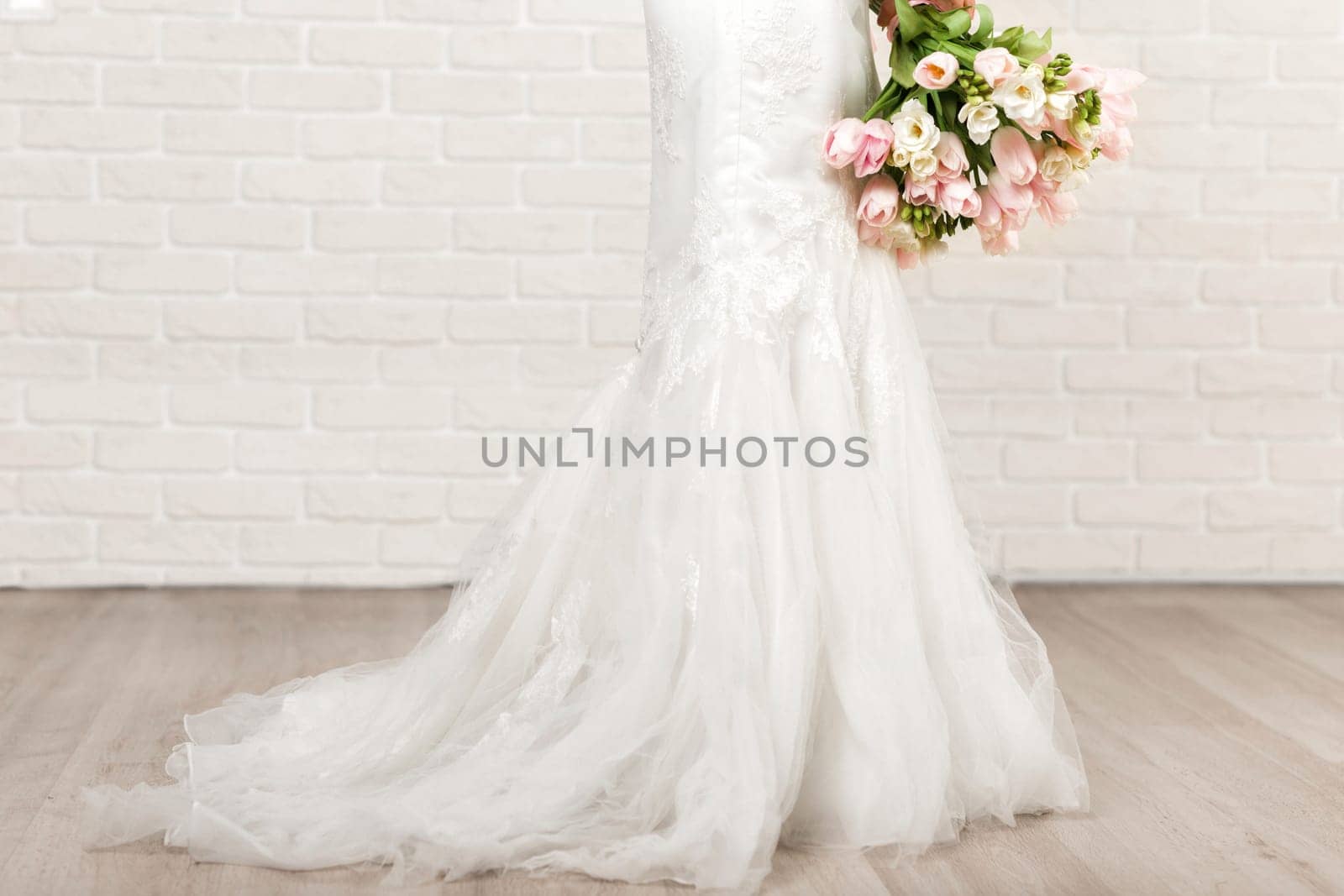 Wedding bouquet of pink tulips in bride's hands