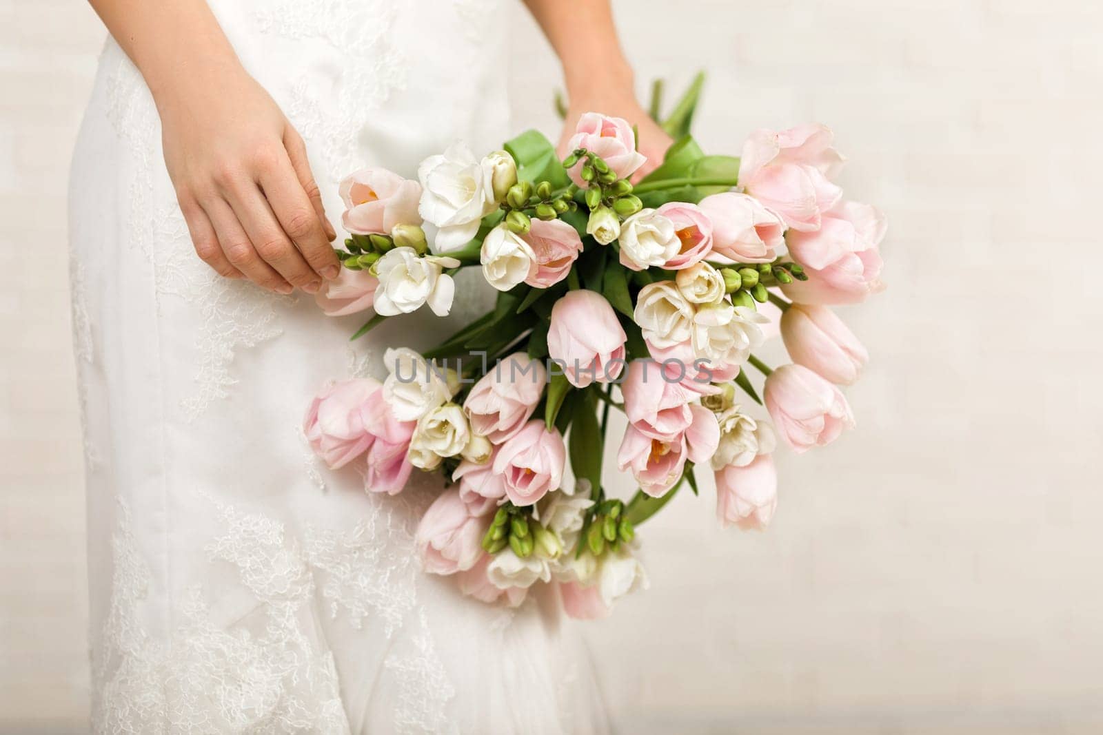 Wedding bouquet of pink tulips in bride's hands