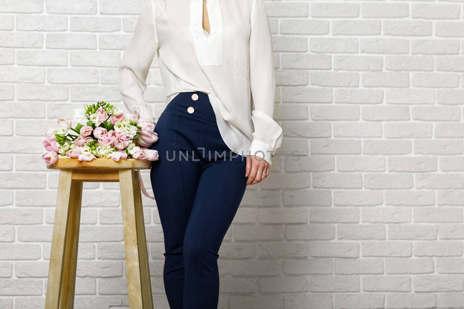 woman with a bouquet of tulips flowers on chair