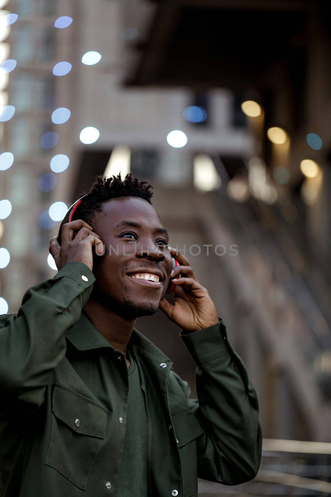 african-american man in wireless headphones listening music by erstudio