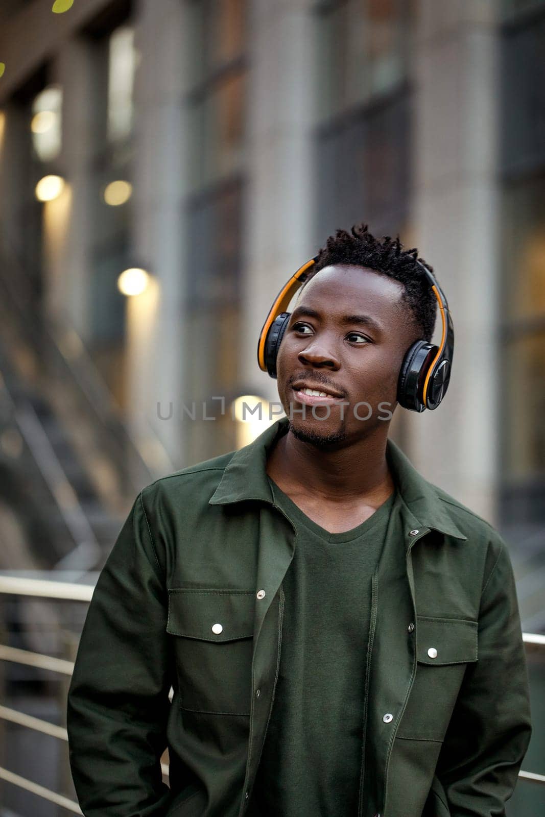 african-american man in wireless headphones listening music by erstudio
