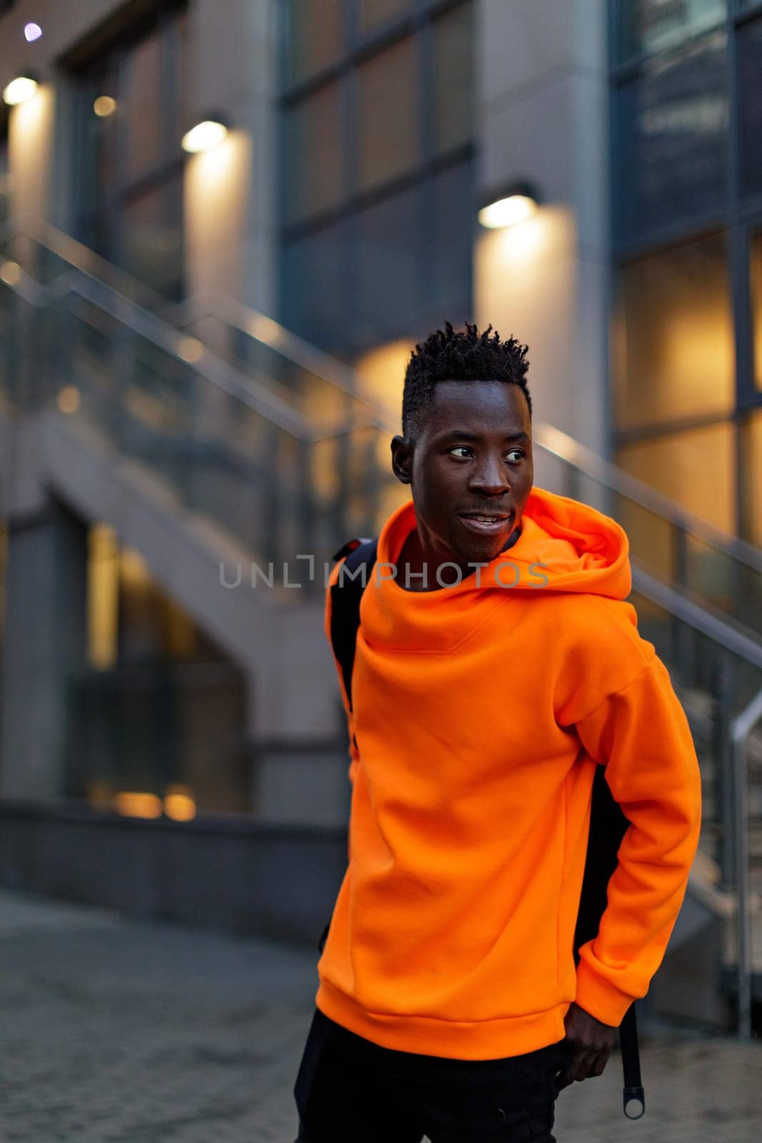african-american man in stylish orange hoodie by erstudio