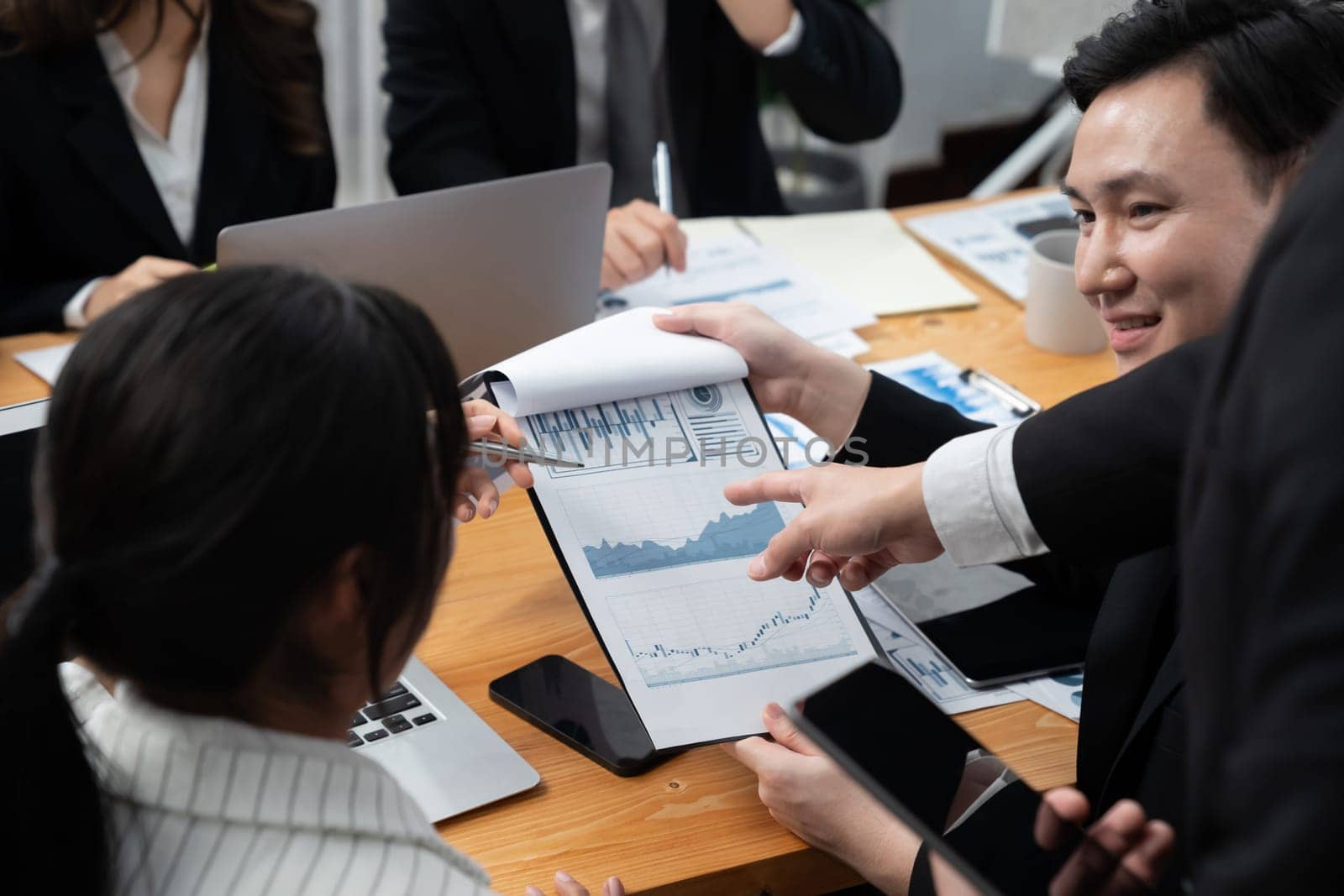 Business team of financial data analysis meeting with business intelligence, report paper and dashboard on laptop for marketing strategy. Business people working together to promote harmony in office.