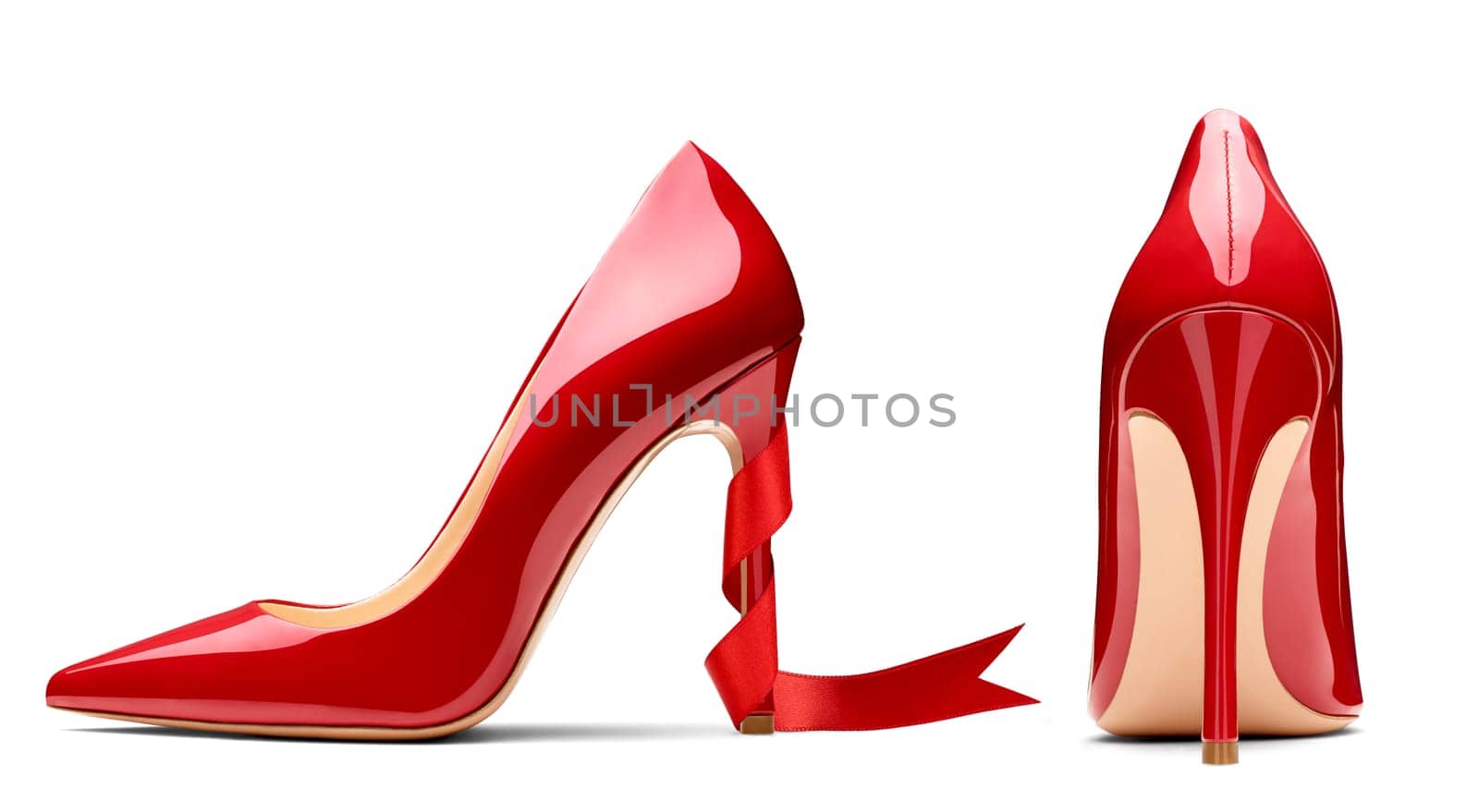 close up of red high heels and ribbon on white background