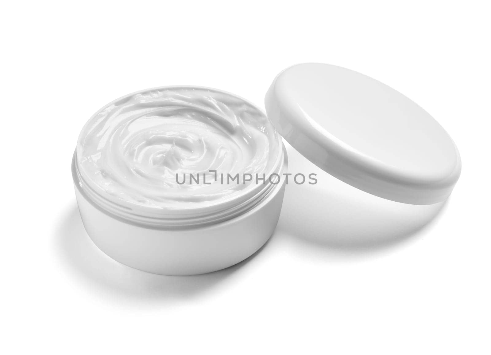 close up of a white beauty cream in a container on white background