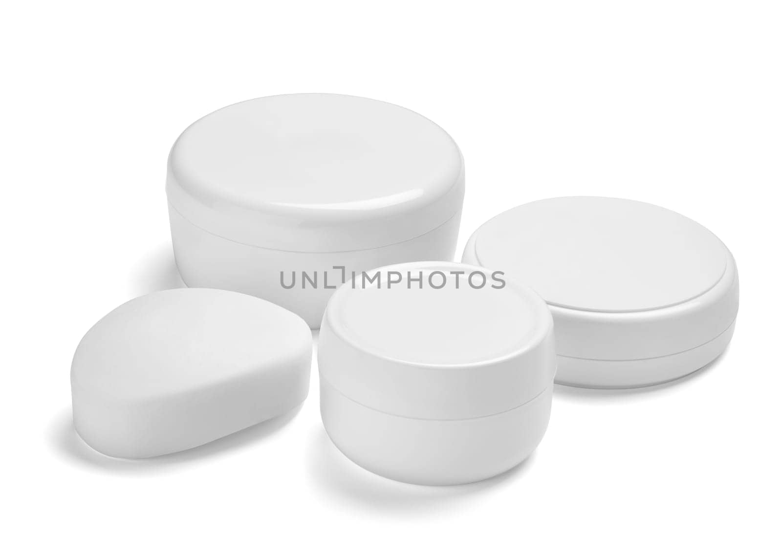 close up of a white beauty cream container and tube on white background