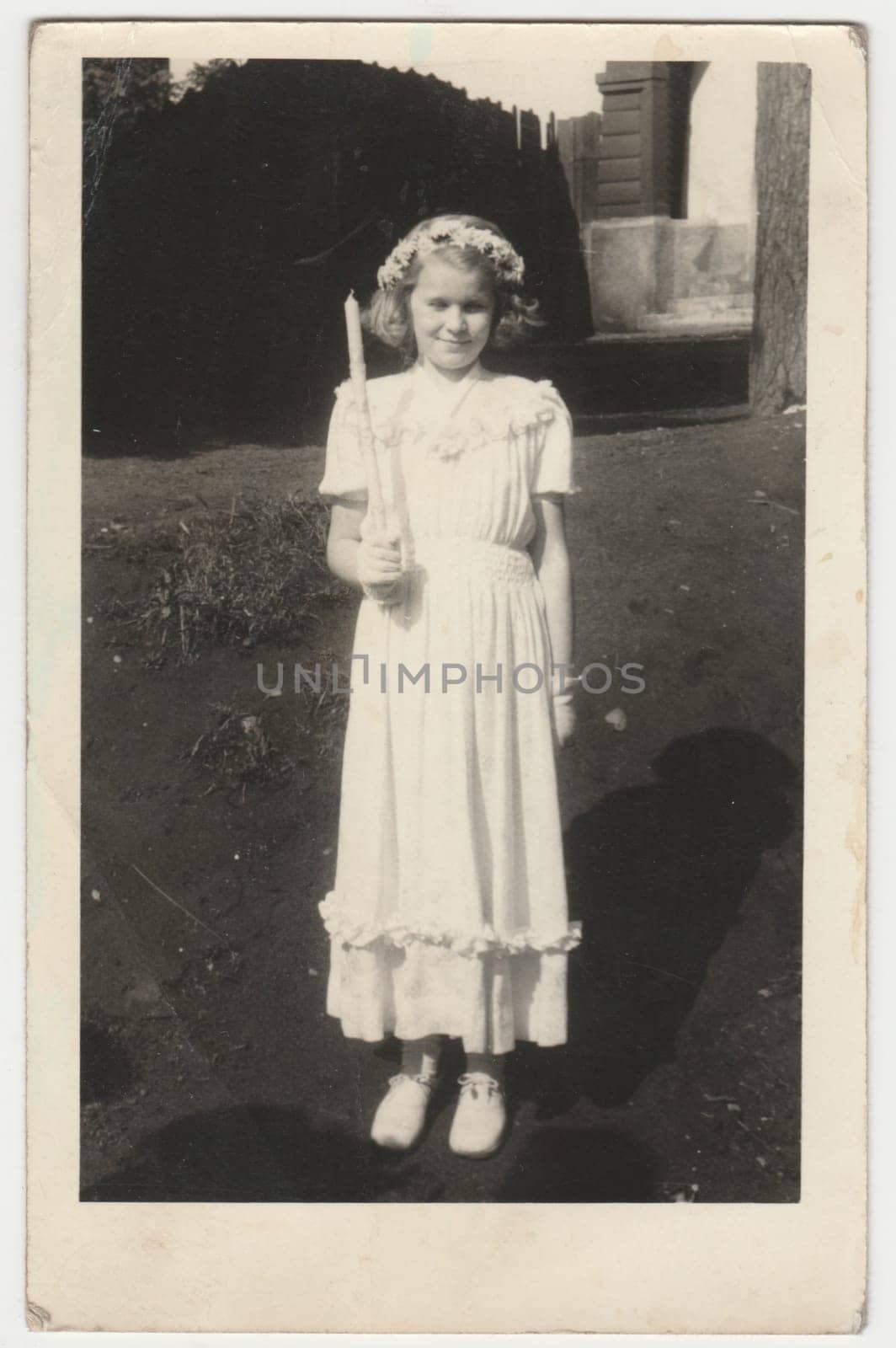 intage photo shows girl after her first communion. Retro black and white photography. Circa 1950s. by roman_nerud