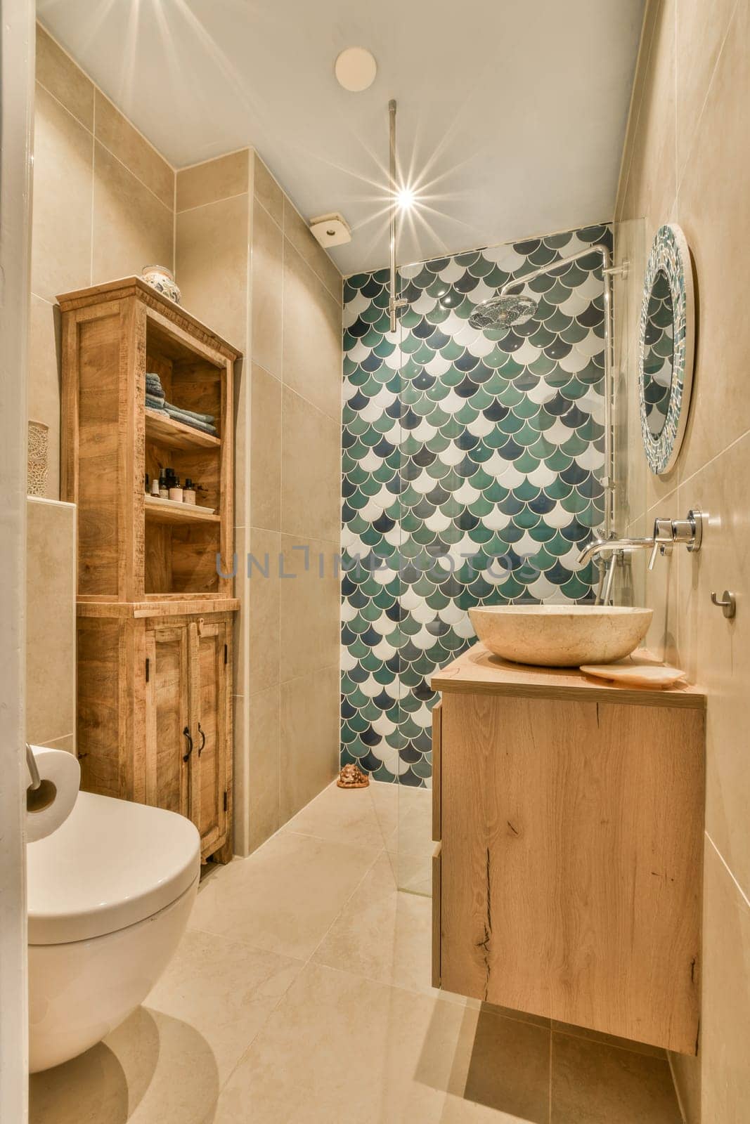 a bathroom with blue and white tiles on the walls, wood cabinets in the corner, and a wooden sink