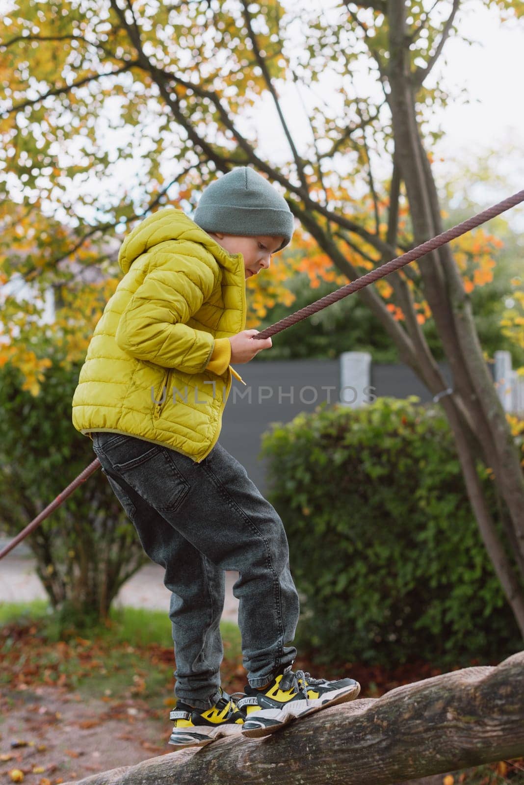 Funny cute happy baby playing on the playground. The emotion of happiness, fun, joy. Smile of a child. boy playing on the playground by Andrii_Ko