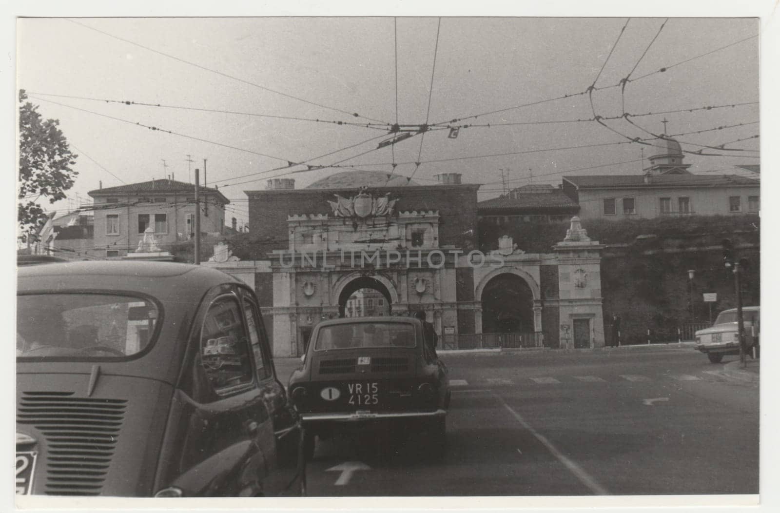 Vintage photo shows the heavy traffic in Italian town. Retro black and white photography. Circa 1970s. by roman_nerud