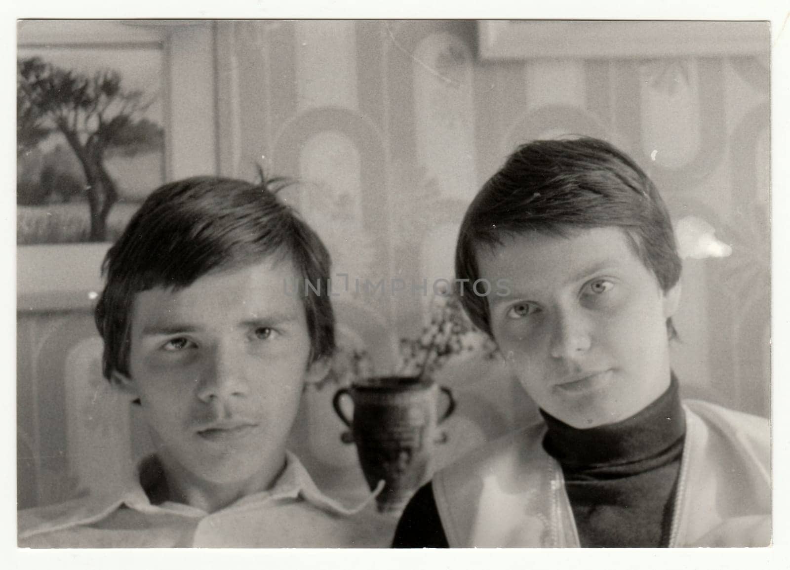 Vintage photo shows a portrait of two adolescent brothers. Retro black and white photography. Circa 1980s. by roman_nerud