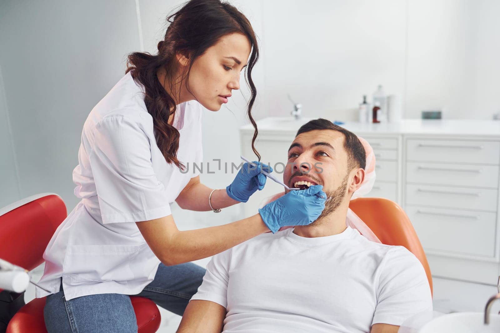 Man visiting dentist in clinic. Conception of stomatology.
