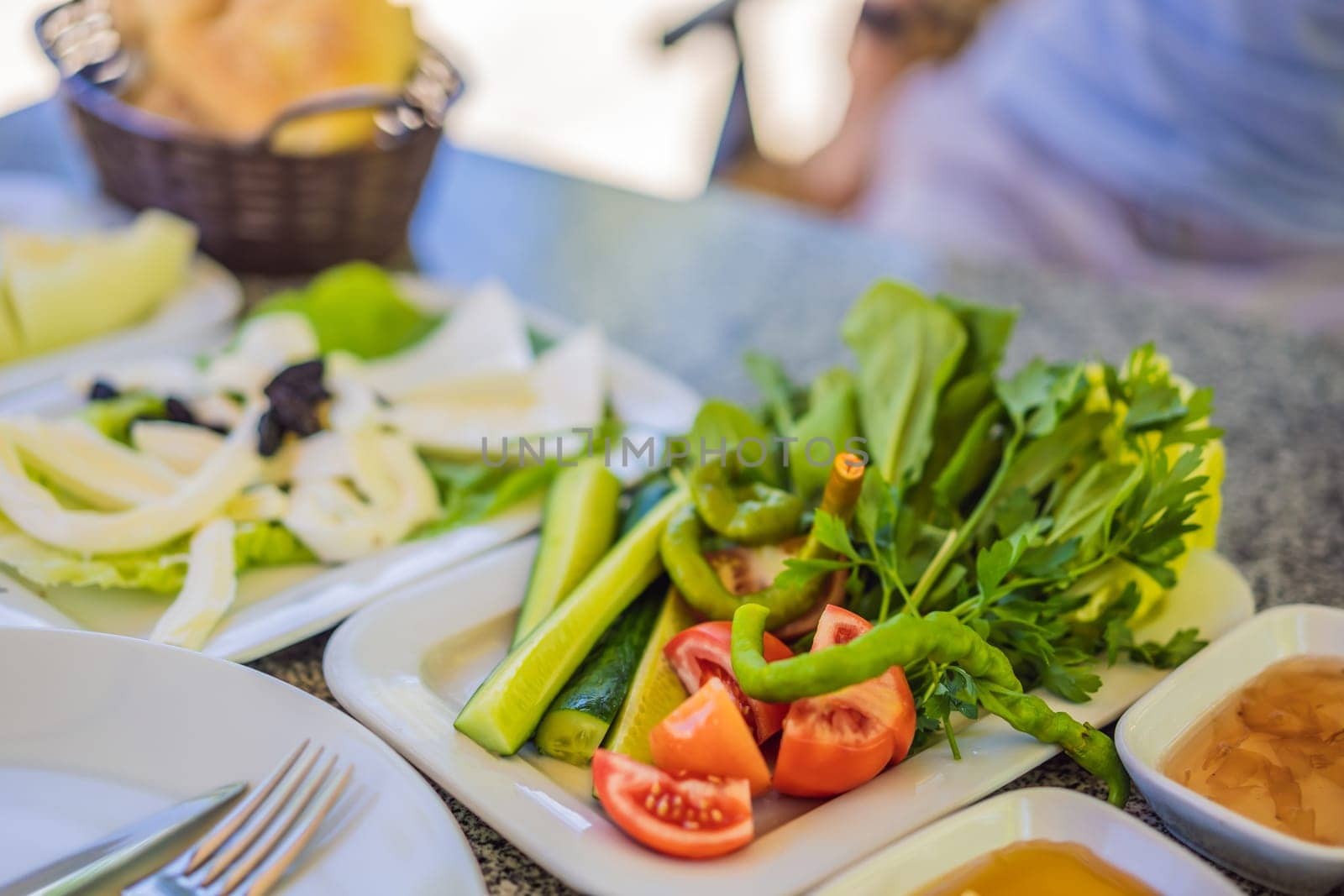 Turkish breakfast table. Pastries, vegetables, greens, olives, cheeses, fried eggs, spices, jams, honey, tea in copper pot and tulip glasses, wide composition by galitskaya