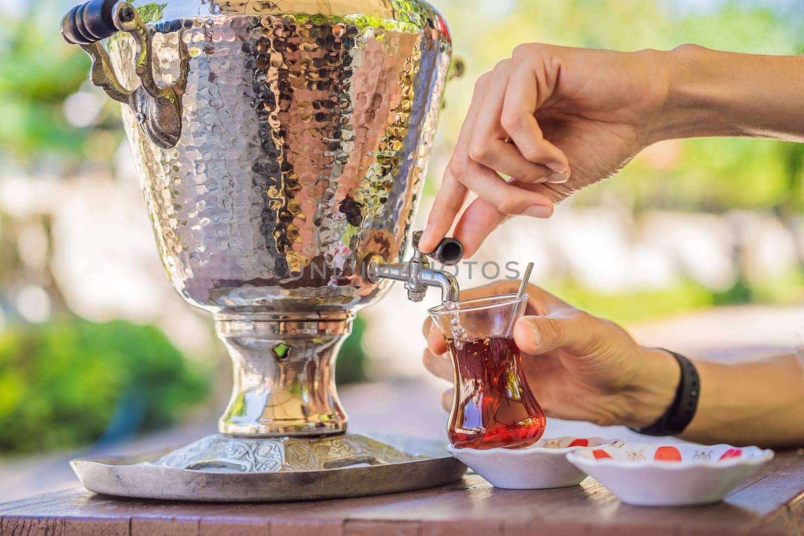 Drinking Traditional Turkish Tea with Turkish tea cup and copper tea pot.