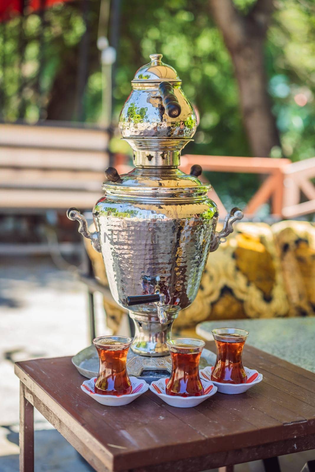 Drinking Traditional Turkish Tea with Turkish tea cup and copper tea pot.