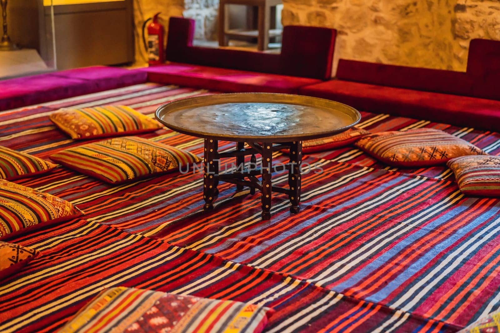 Turkish traditional antique carpets interior. table and pillows by galitskaya