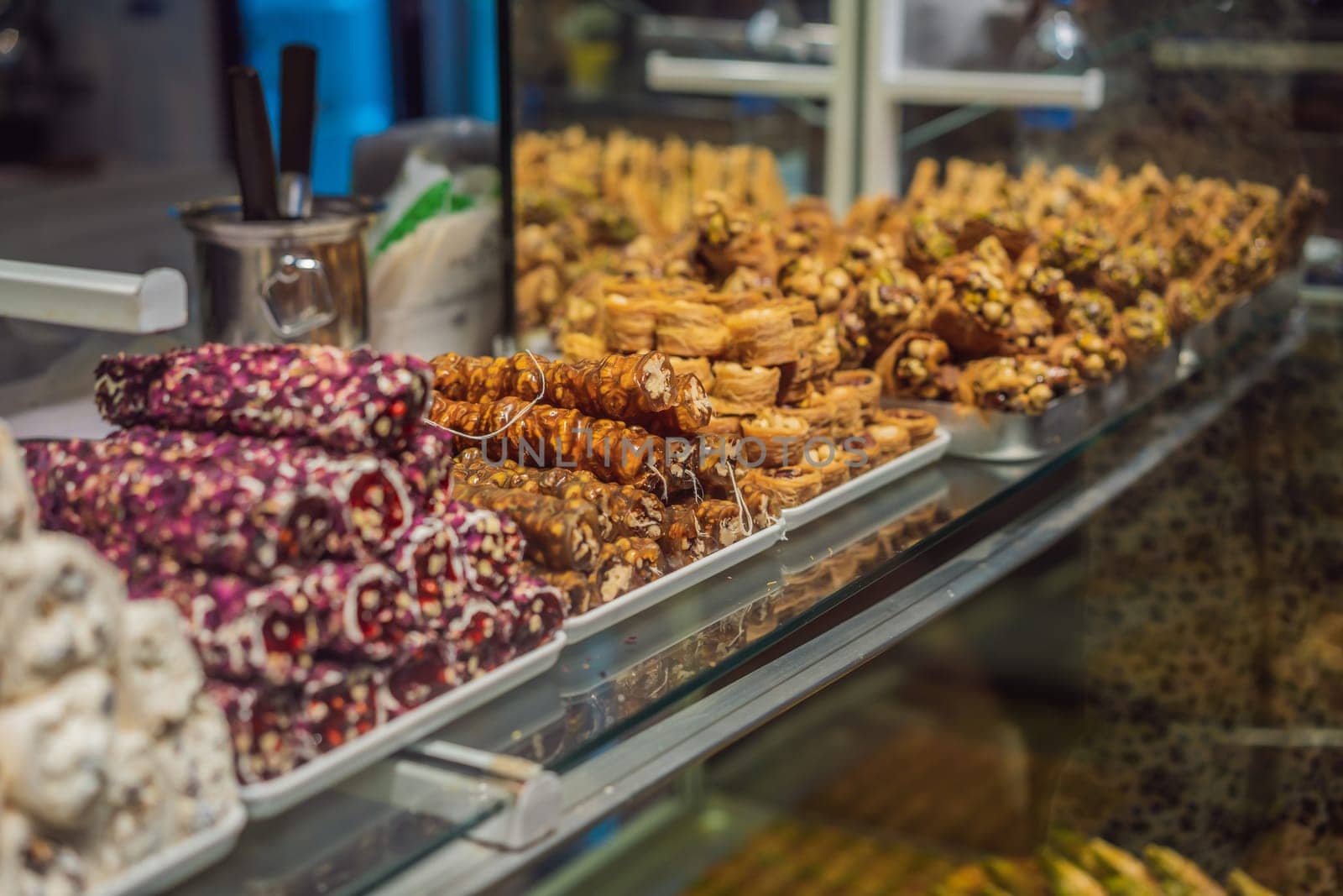 Traditional oriental sweet pastry cookies, nuts, dried fruits, pastilles, marmalade, Turkish desert with sugar, honey and pistachio, in display at a street food market.