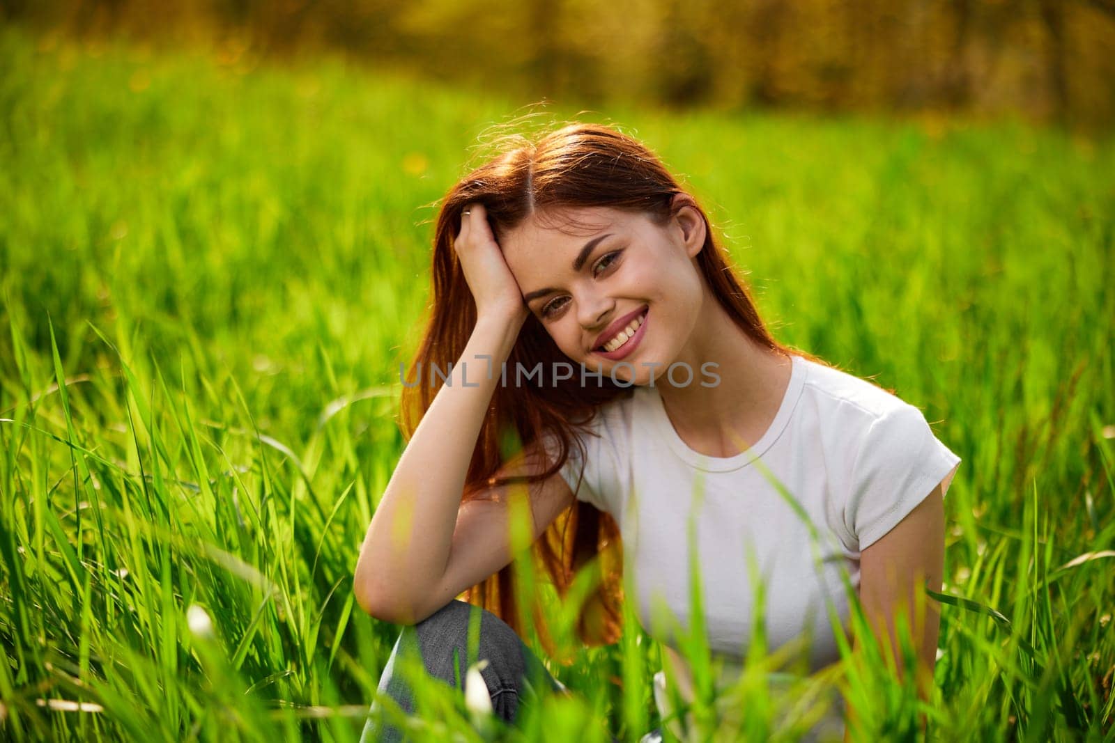 Beautiful young woman close up portrait among green cereal grass by Vichizh