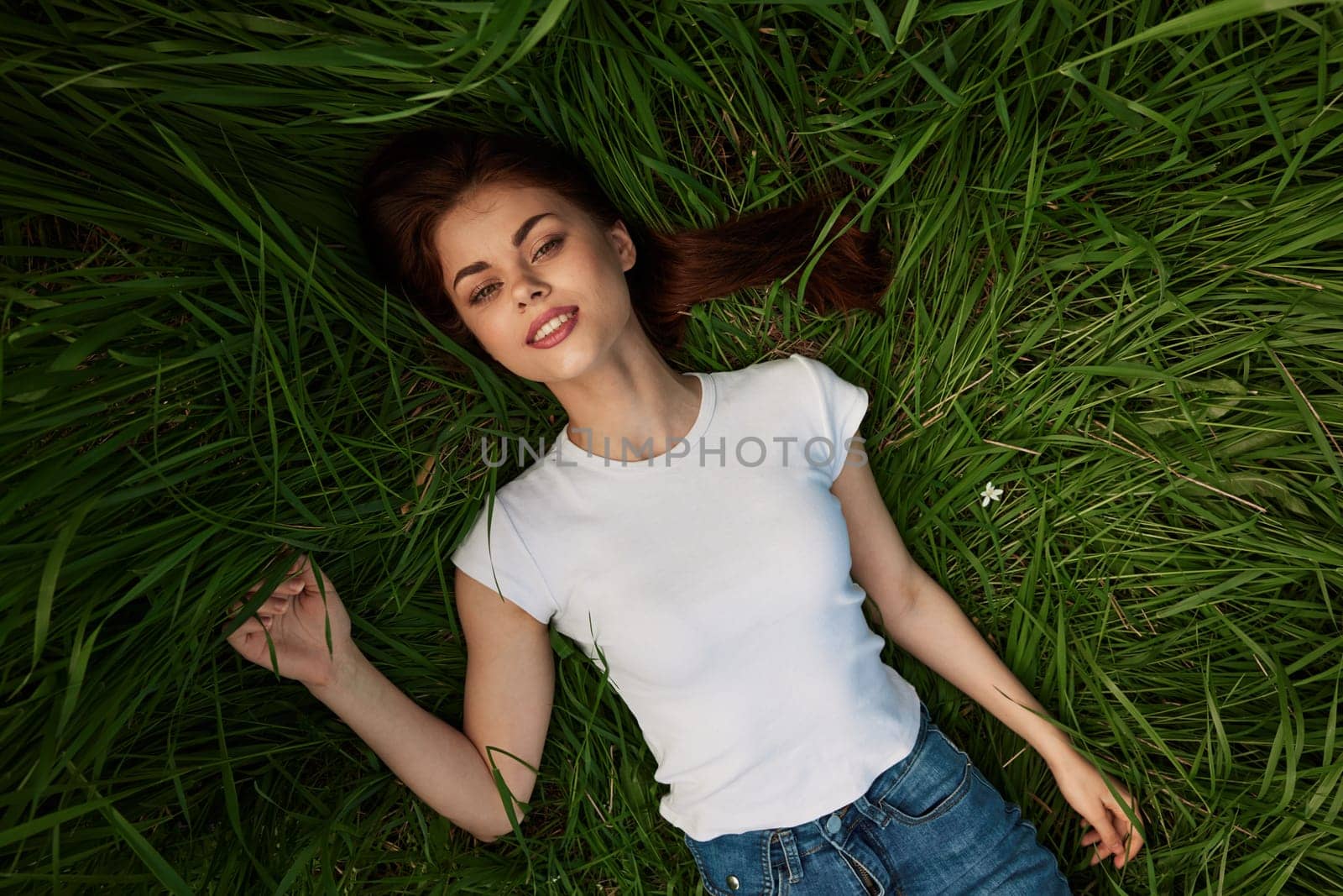 woman dreaming lying on the grass by Vichizh
