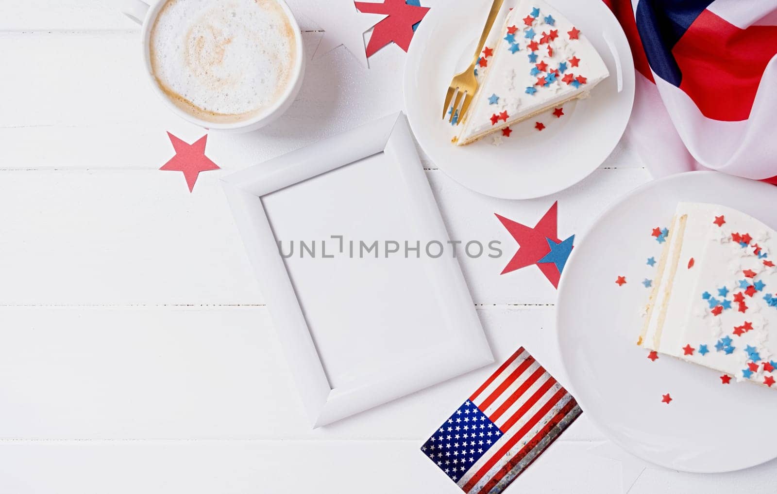 Fourth of july celebration. Sweet cake with usa flag colored sprinkles and stars and white framw for mockup design , flag background top view flat lay