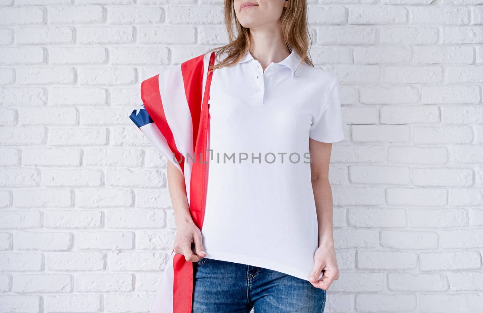 White polo shirt on woman over USA flag background, mockup design by Desperada