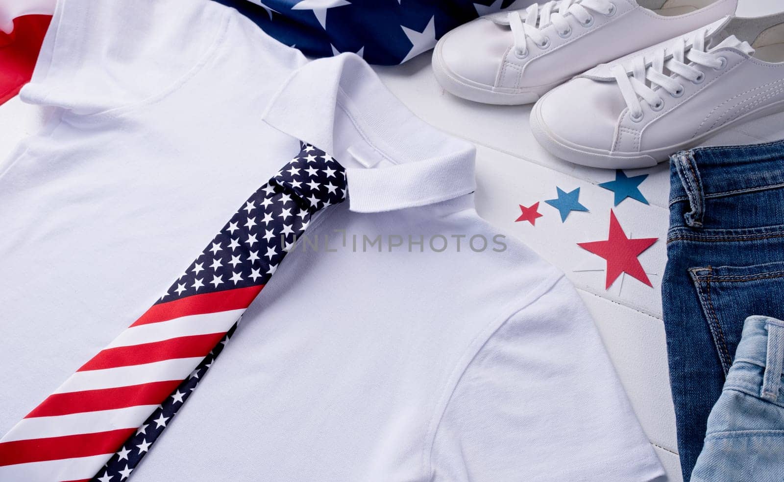 USA Memorial day, Presidents day, Veterans day, Labor day, or 4th of July celebration. Mockup design white polo t shirt for logo, top view on white wooden background with US flag, shoes and jeans