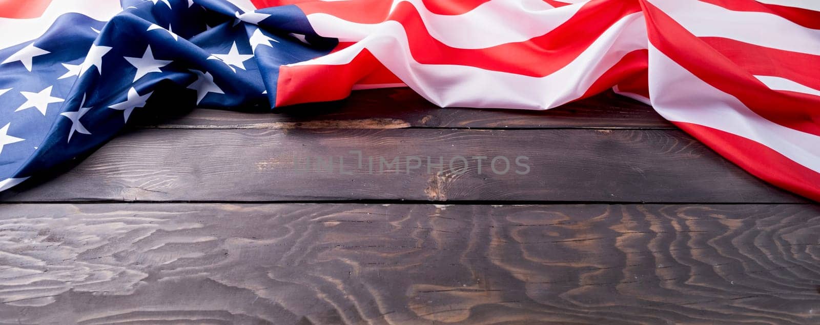 Closeup of American flag on dark wooden background by Desperada