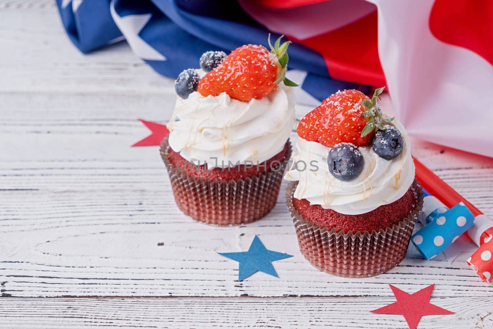 Sweet cupcakes with blueberries and strawberry , usa flag on blue background by Desperada