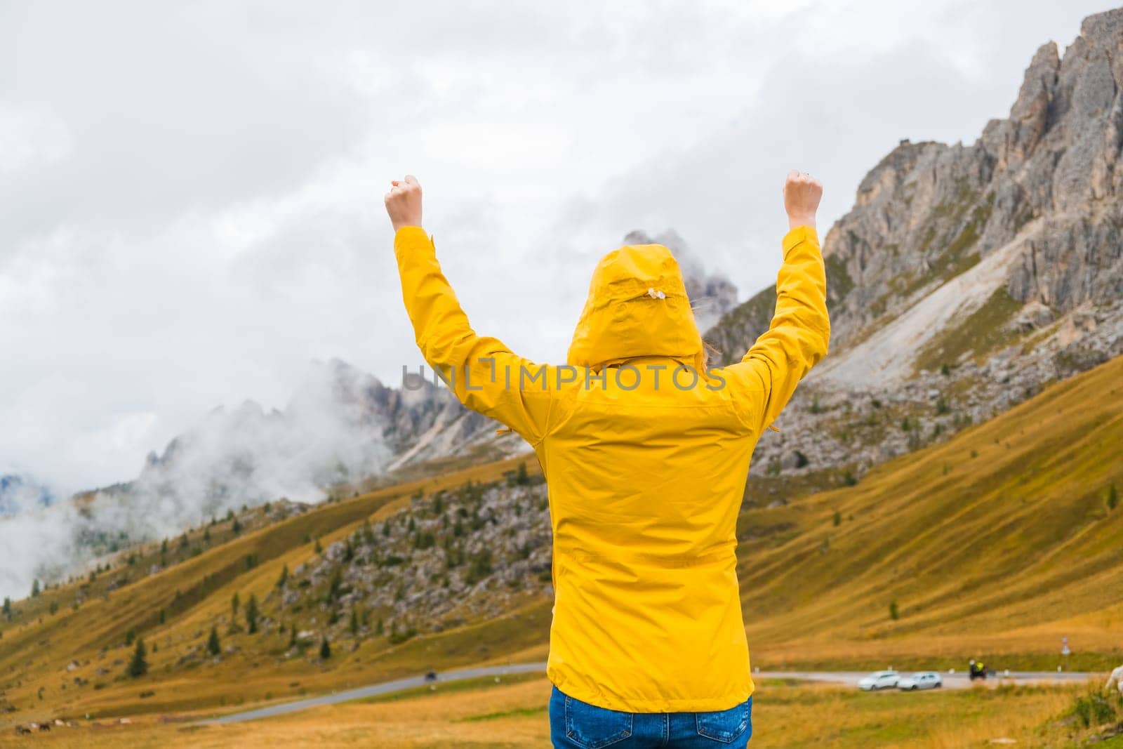Happy male tourist spreads hands and enjoys the Alps by vladimka