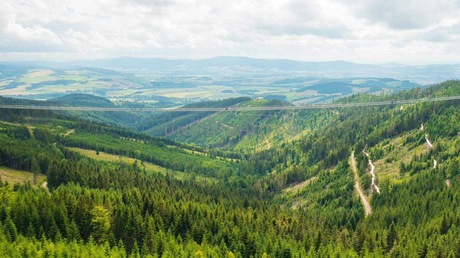 Sky Bridge 721 is the longest suspension bridge between two hills in the forest, Dolni Morava, Czech Republic . One way footbridge in touristic place in the forest in summer.