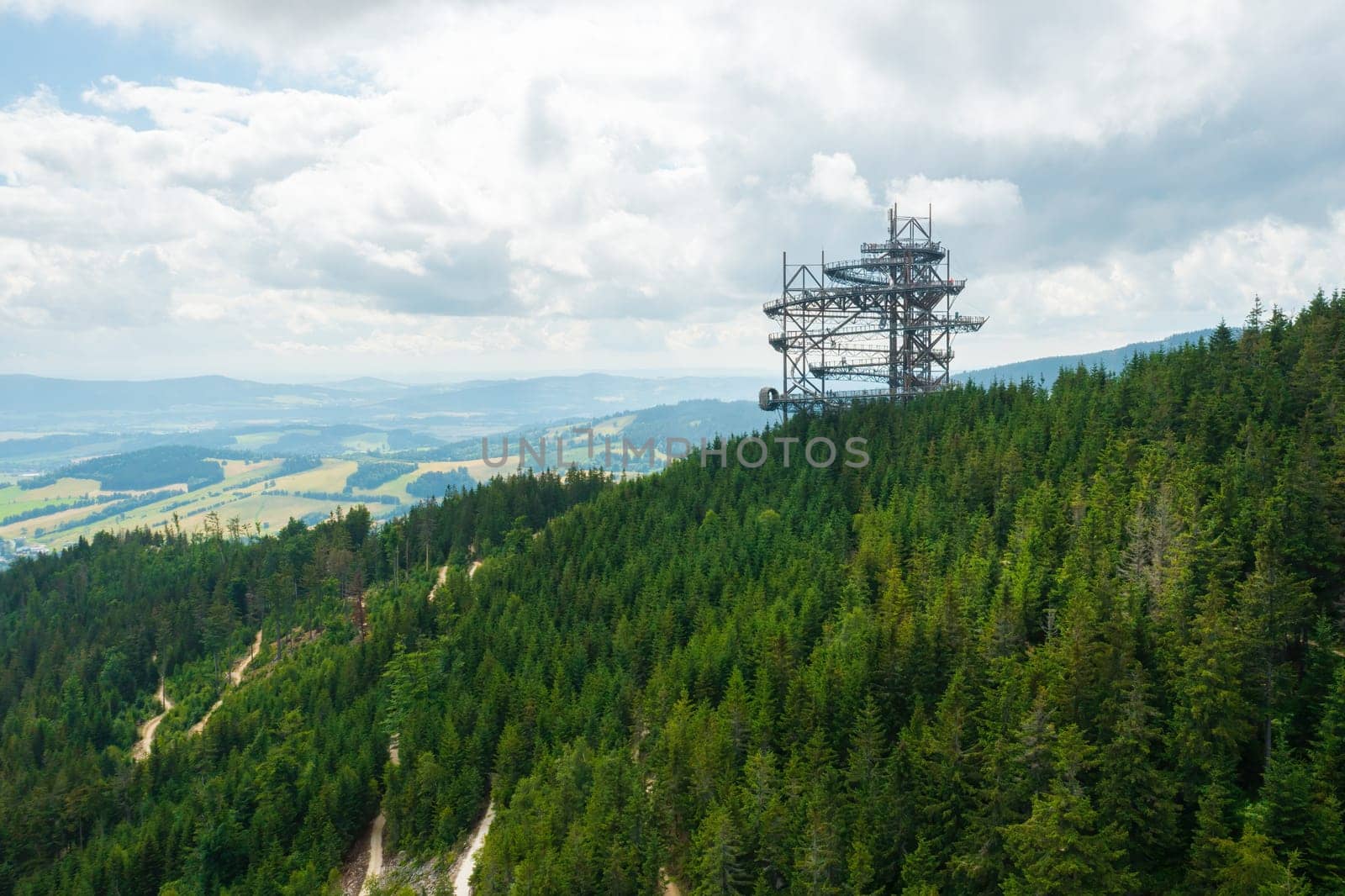 Sky walk observation tower in the forest between mountain hills near Sky Bridge 721 in a sunny summer day, Dolni Morava, Czech Republic.
