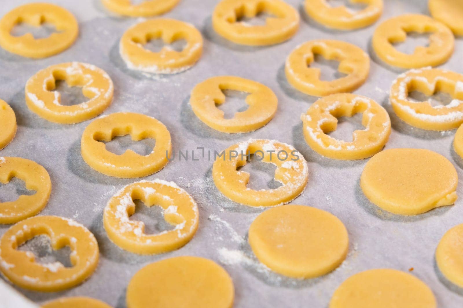 Sugar cookies in the shape of angels on the baking paper ready for baking for St Valentines Day. Home made biscuits