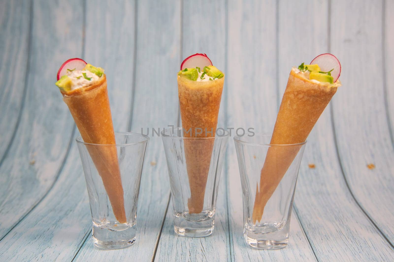 Brick cone with tuna sauce, mayonnaise, avocado and radish slice, High quality photo