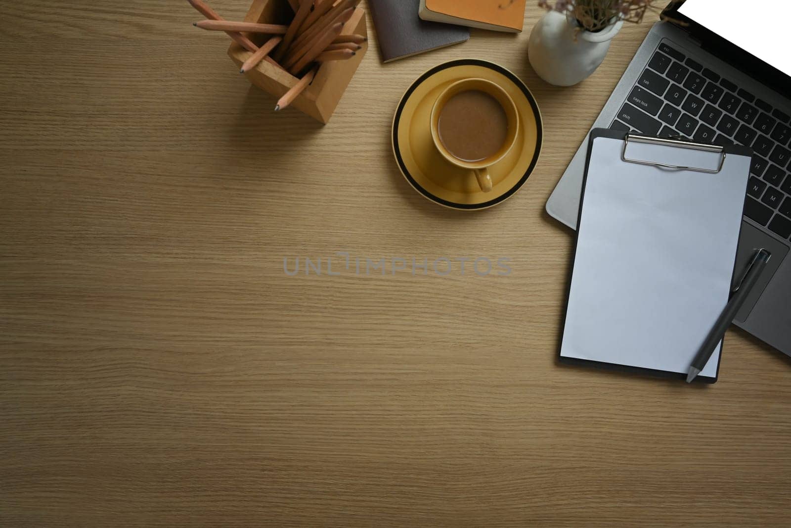 Laptop computer and cup of coffee on wooden working desk. Top view, Flat lay with copy space.