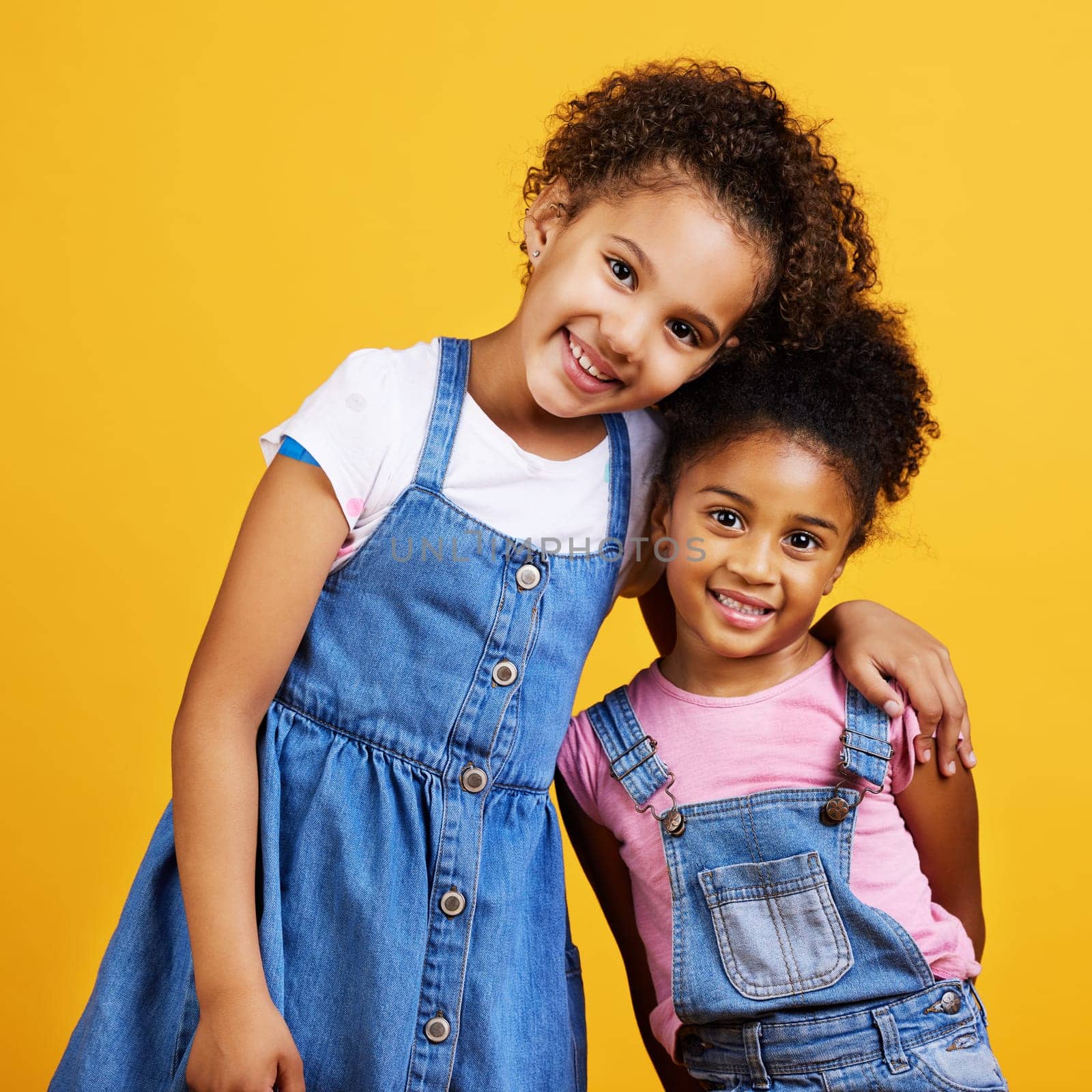 Children, smile portrait and happy sisters in studio with love, care and support of family on yellow background. Cute young girl kids or friends together for happiness, hug or trust with mockup space.