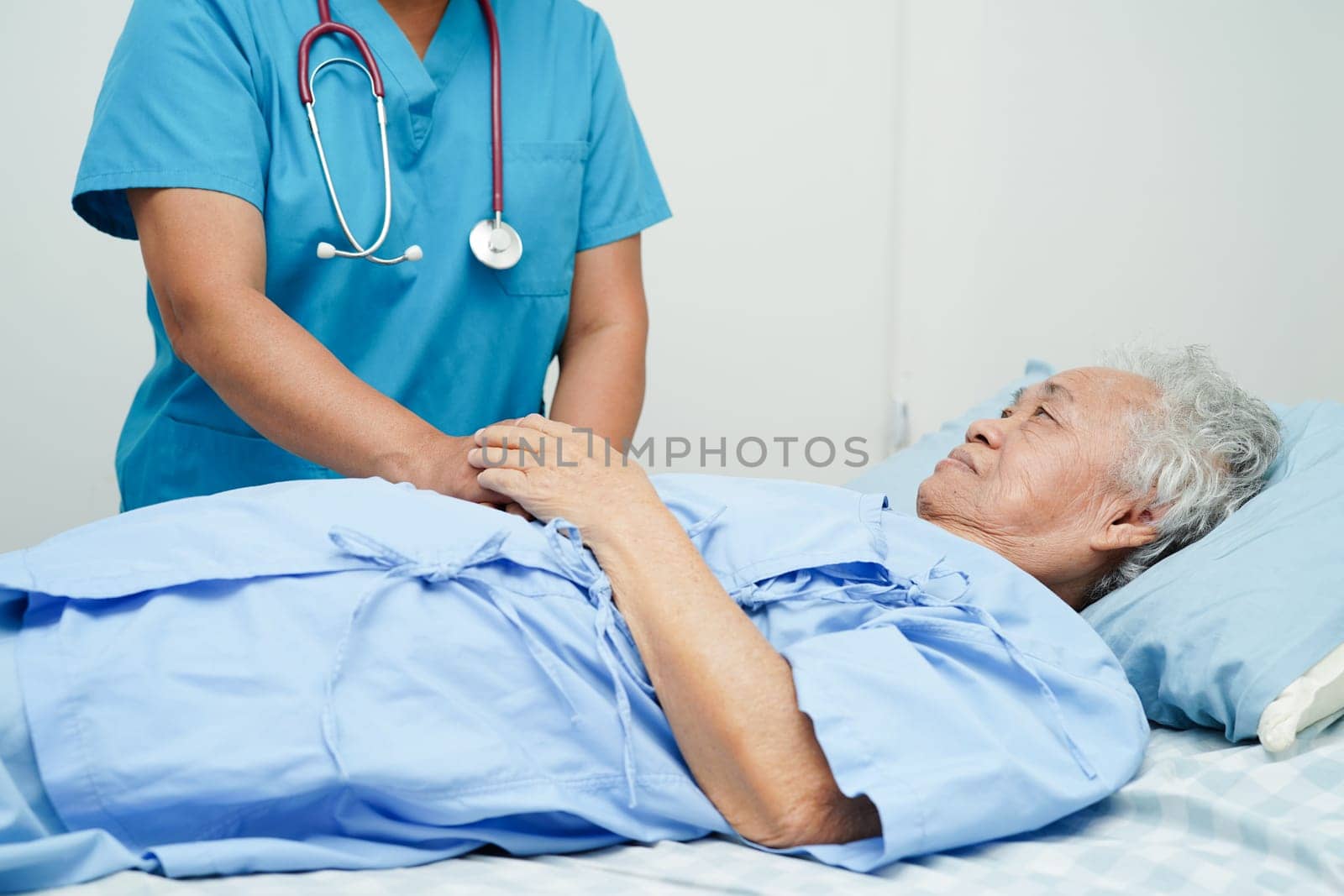 Doctor holding hands Asian elderly woman patient, help and care in hospital.