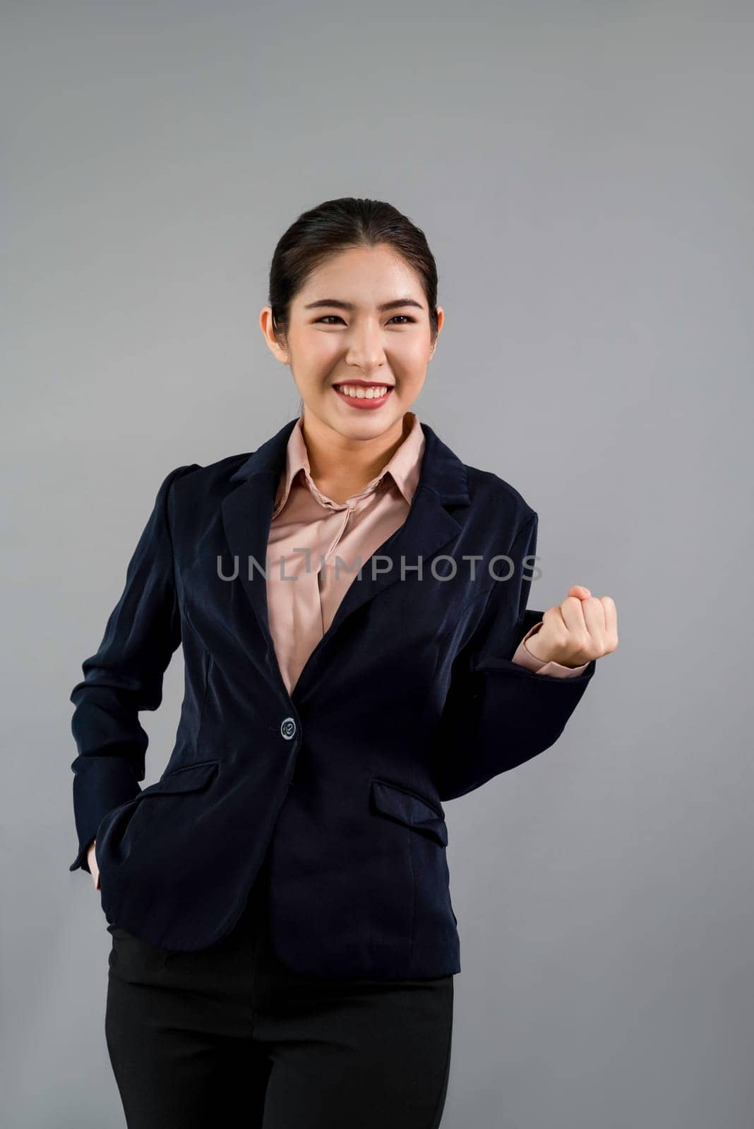Confident young asian businesswoman in formal suit making hand gesture to indicate promotion or advertising with surprised face expression and gesture on isolated background. Enthusiastic