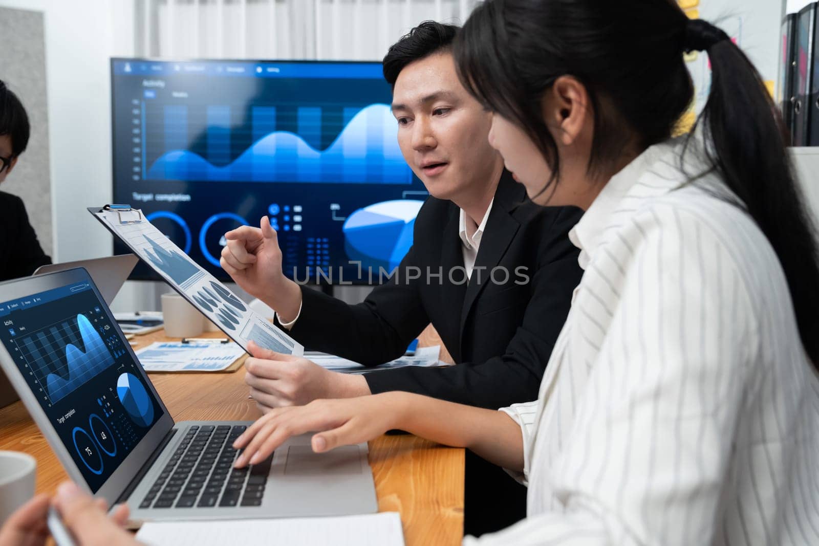 Business team of financial data analysis meeting with business intelligence, report paper and dashboard on laptop for marketing strategy. Business people working together to promote harmony in office.