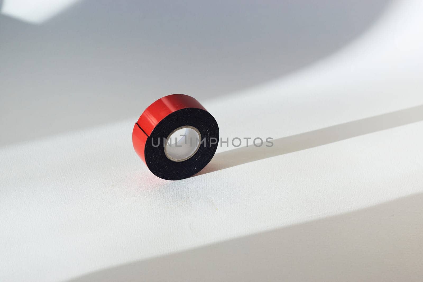 Double sided adhesive tape in red color on white background