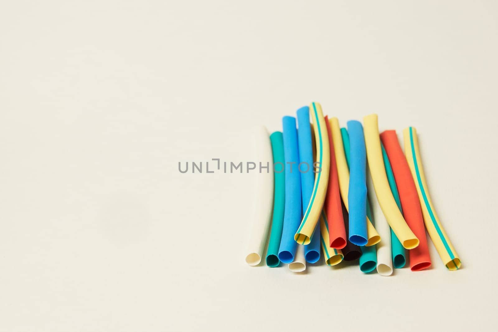 A set of shrinkable colored tubes on a white background by Севостьянов