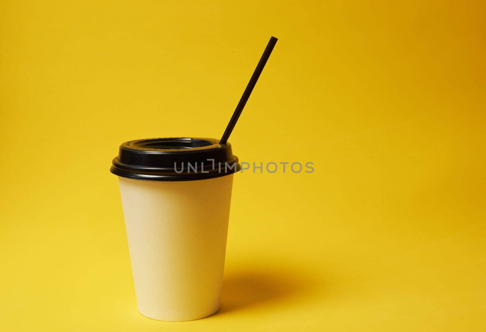 Paper Coffee Container with Black Lid on Yellow Background White Coffee Paper Cup with Black Lid on Yellow Background Takeaway Coffee